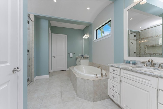 bathroom featuring tile patterned flooring, vanity, and shower with separate bathtub