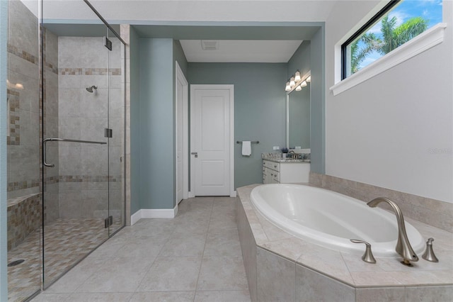 bathroom featuring tile patterned floors, vanity, and shower with separate bathtub