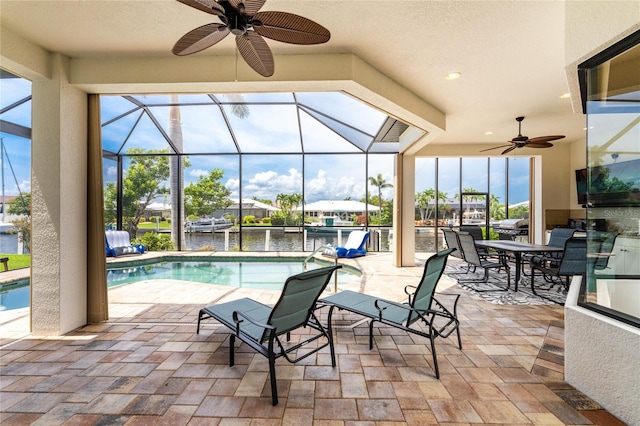 view of pool with a lanai, ceiling fan, and a patio area