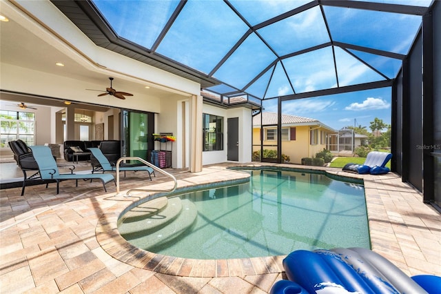 view of swimming pool featuring ceiling fan, glass enclosure, and a patio area