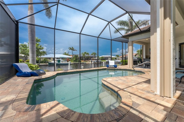 view of pool with a patio area, a lanai, and a water view