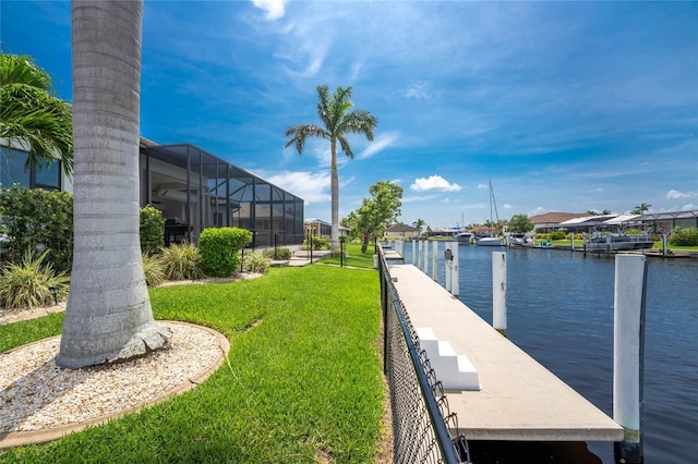 dock area featuring a water view and a lawn