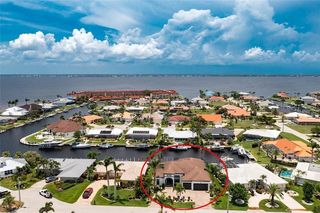 birds eye view of property with a water view