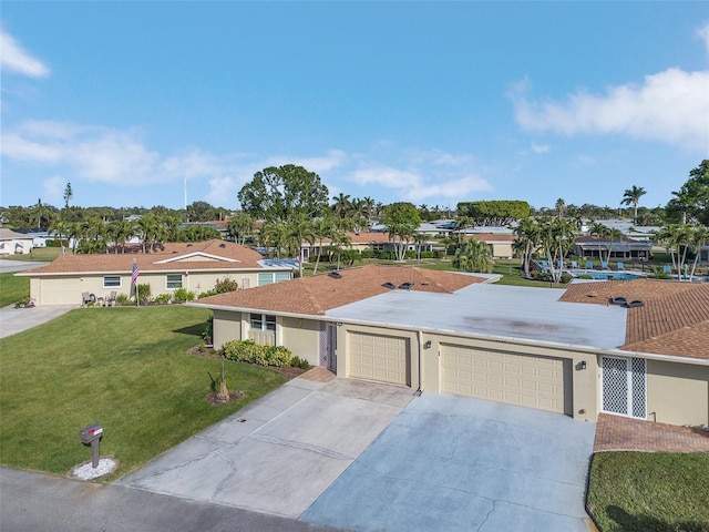 ranch-style home featuring a garage and a front lawn