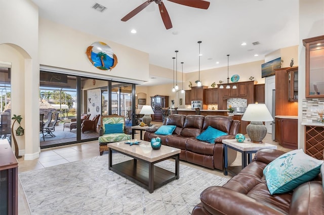 tiled living room with ceiling fan