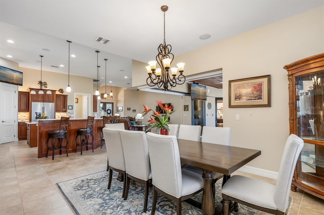 dining room with a notable chandelier and light tile patterned flooring