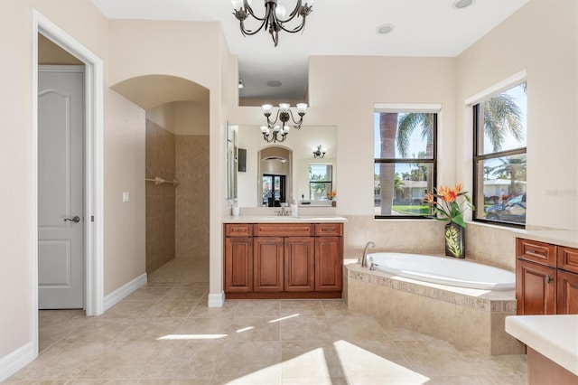 bathroom featuring separate shower and tub, tile patterned flooring, vanity, and a notable chandelier