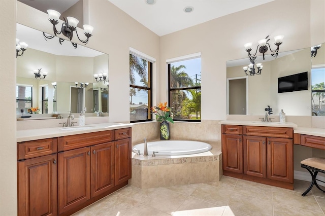 bathroom featuring tile patterned flooring, vanity, a relaxing tiled tub, and a chandelier