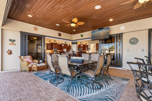 interior space with ceiling fan and wood ceiling