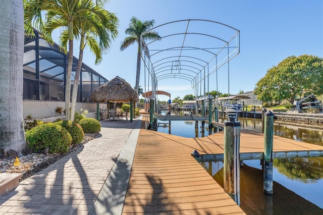 view of dock with a gazebo, glass enclosure, and a water view