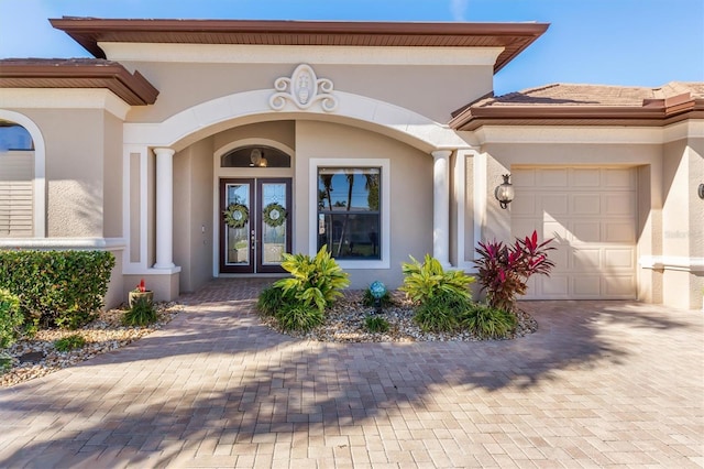 entrance to property featuring french doors and a garage