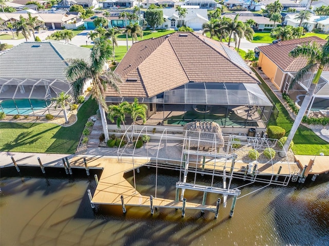 dock area featuring glass enclosure and a water view