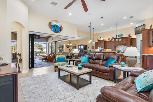 tiled living room with ceiling fan and beverage cooler