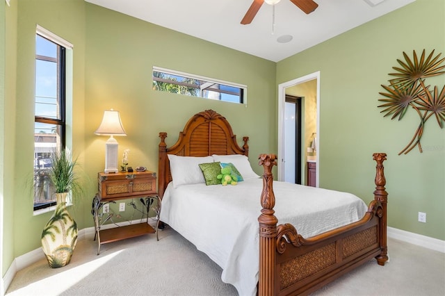 bedroom with carpet flooring, ensuite bath, and ceiling fan