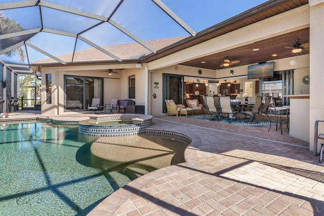 view of swimming pool featuring ceiling fan, a patio area, an in ground hot tub, and glass enclosure