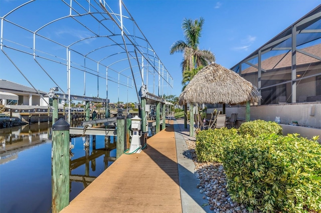 view of dock featuring glass enclosure and a water view