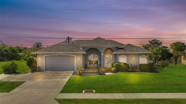228 Nicholas Pkwy E, Cape Coral, FL 33990 - ranch-style home with a garage, stucco siding, driveway, and a front lawn