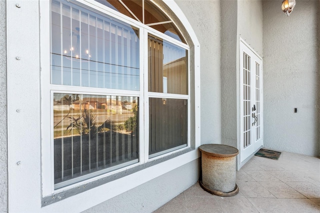 228 Nicholas Pkwy E, Cape Coral, FL 33990 - doorway to property featuring french doors and stucco siding