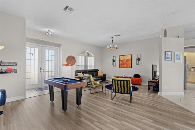 228 Nicholas Pkwy E, Cape Coral, FL 33990 - playroom with an inviting chandelier, light wood-style floors, visible vents, and baseboards