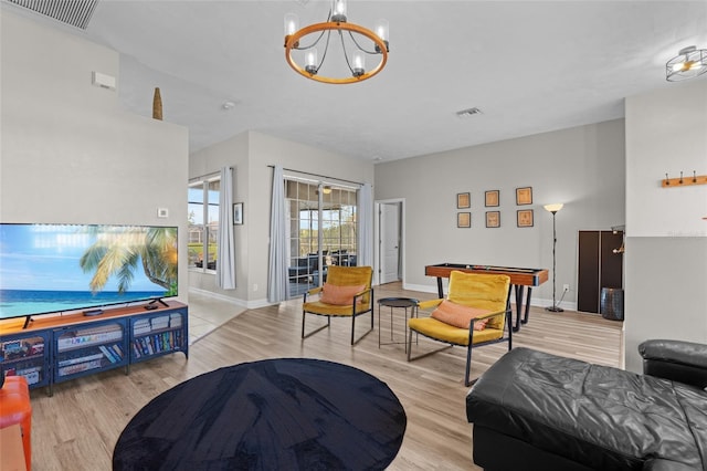 228 Nicholas Pkwy E, Cape Coral, FL 33990 - living area featuring a chandelier, baseboards, visible vents, and wood finished floors