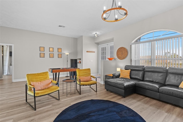 228 Nicholas Pkwy E, Cape Coral, FL 33990 - living room with baseboards, a chandelier, visible vents, and light wood-style floors