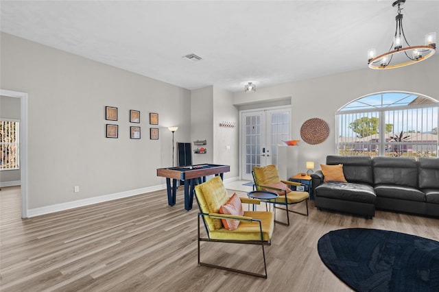 228 Nicholas Pkwy E, Cape Coral, FL 33990 - living room with visible vents, a healthy amount of sunlight, light wood-type flooring, pool table, and french doors