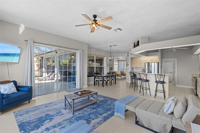 228 Nicholas Pkwy E, Cape Coral, FL 33990 - living area with baseboards, ceiling fan, visible vents, and light tile patterned floors