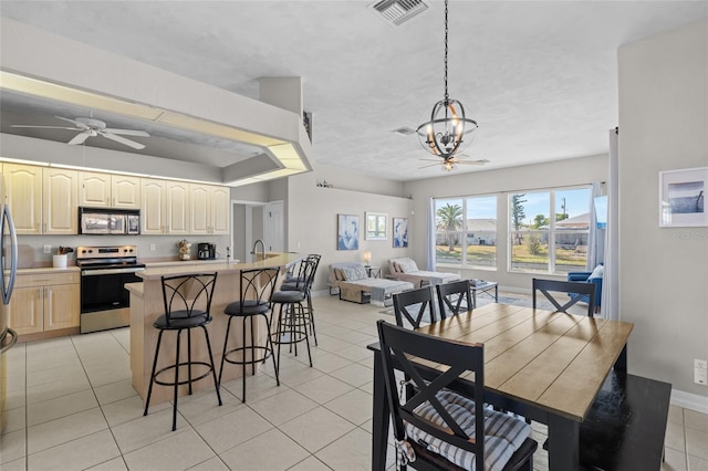 228 Nicholas Pkwy E, Cape Coral, FL 33990 - dining area with visible vents, baseboards, ceiling fan with notable chandelier, and light tile patterned flooring