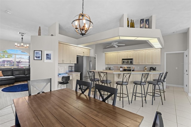 228 Nicholas Pkwy E, Cape Coral, FL 33990 - dining space with lofted ceiling, ceiling fan with notable chandelier, baseboards, and light tile patterned floors