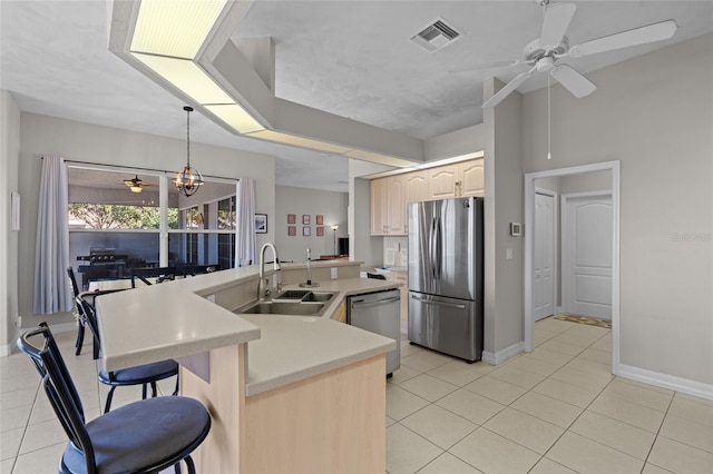 228 Nicholas Pkwy E, Cape Coral, FL 33990 - kitchen with a ceiling fan, a sink, appliances with stainless steel finishes, and light tile patterned floors