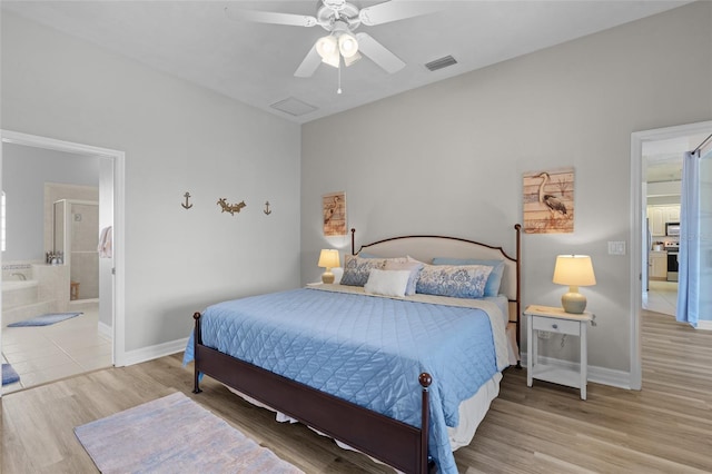 228 Nicholas Pkwy E, Cape Coral, FL 33990 - bedroom featuring light wood finished floors, ensuite bathroom, baseboards, and visible vents