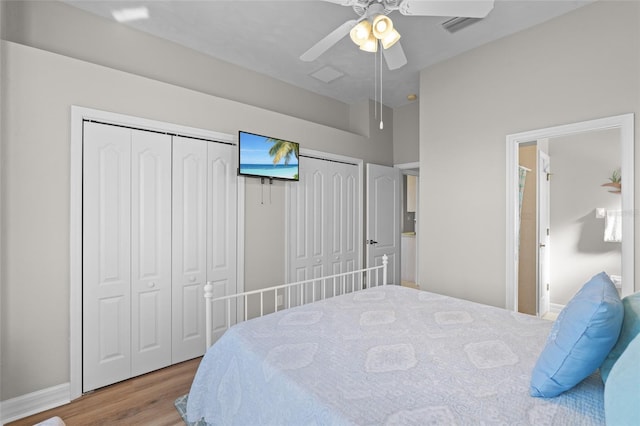 228 Nicholas Pkwy E, Cape Coral, FL 33990 - bedroom featuring wood finished floors, visible vents, two closets, a ceiling fan, and baseboards