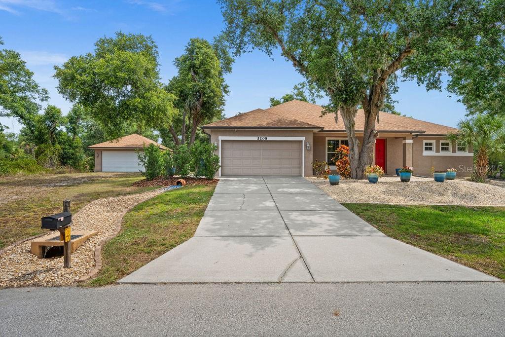 single story home with a front yard and a garage