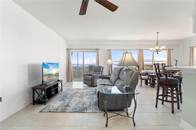 living room with light tile patterned floors and ceiling fan with notable chandelier