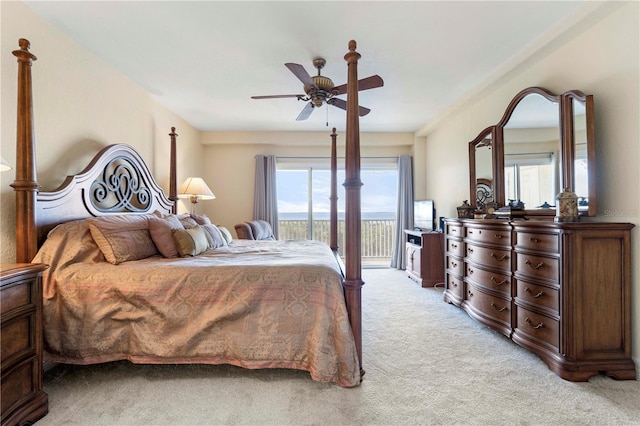 bedroom with access to exterior, light colored carpet, and ceiling fan