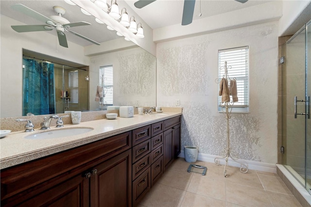 bathroom with tile patterned floors, plenty of natural light, vanity, and an enclosed shower