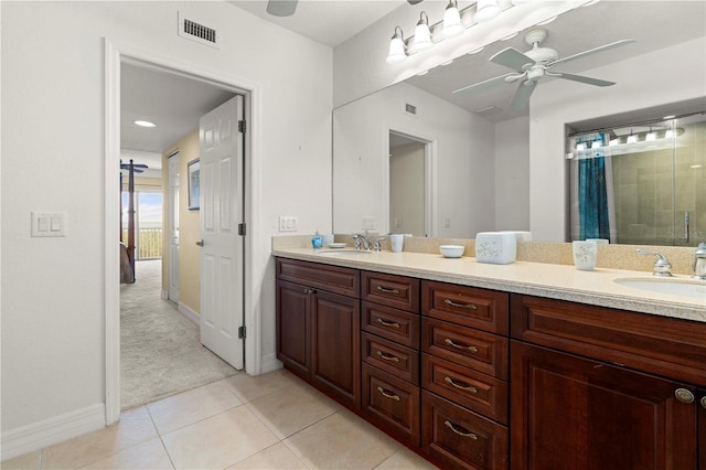 bathroom featuring tile patterned flooring, vanity, ceiling fan, and a shower with shower door