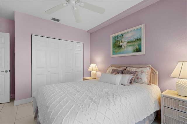 tiled bedroom featuring a closet and ceiling fan