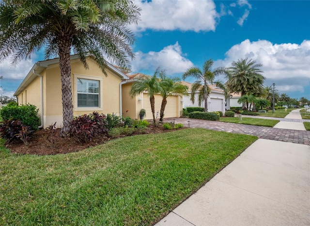 view of front of house with a garage and a front yard