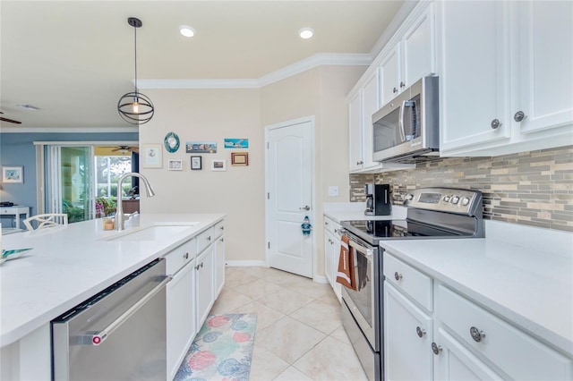 kitchen with light tile patterned floors, stainless steel appliances, white cabinetry, and sink