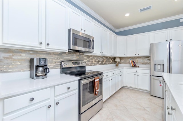 kitchen with backsplash, stainless steel appliances, crown molding, light tile patterned floors, and white cabinetry