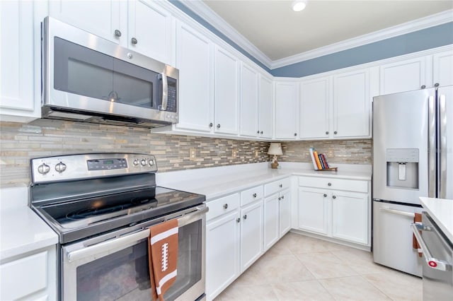 kitchen featuring backsplash, stainless steel appliances, crown molding, white cabinetry, and light tile patterned flooring