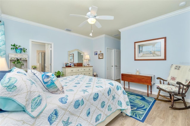 bedroom with a closet, light hardwood / wood-style flooring, ceiling fan, and crown molding