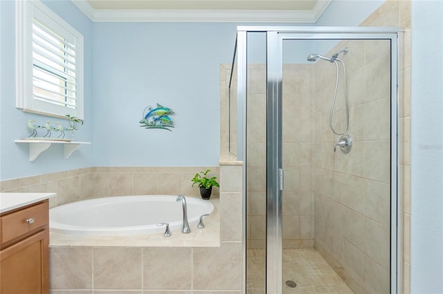 bathroom with vanity, ornamental molding, and shower with separate bathtub