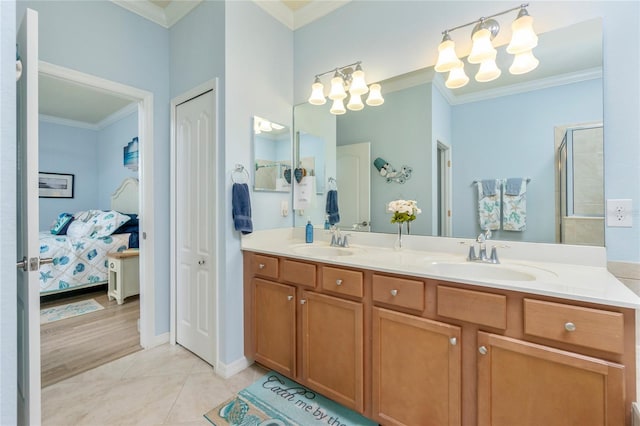 bathroom with tile patterned flooring, vanity, an enclosed shower, and crown molding