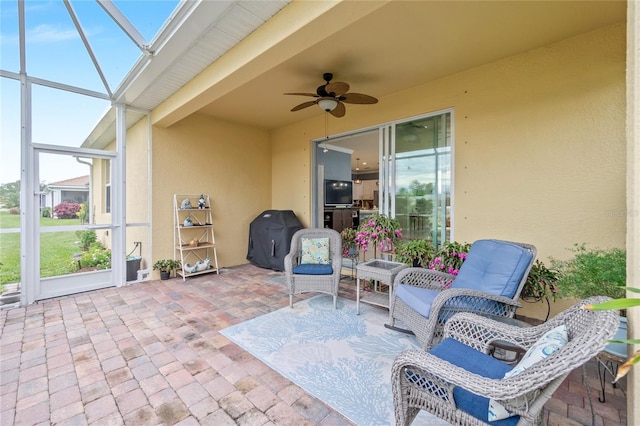 view of patio with a lanai, a grill, and ceiling fan