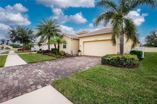 view of front of home featuring a front lawn and a garage