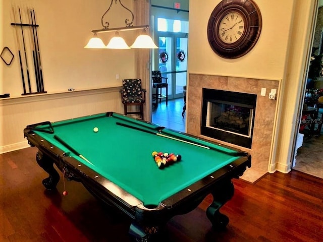 rec room with dark hardwood / wood-style floors, pool table, and a tiled fireplace