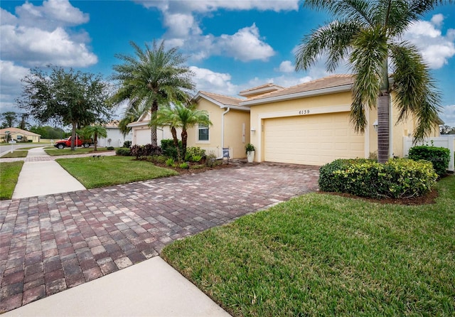 view of front of house with a front yard and a garage