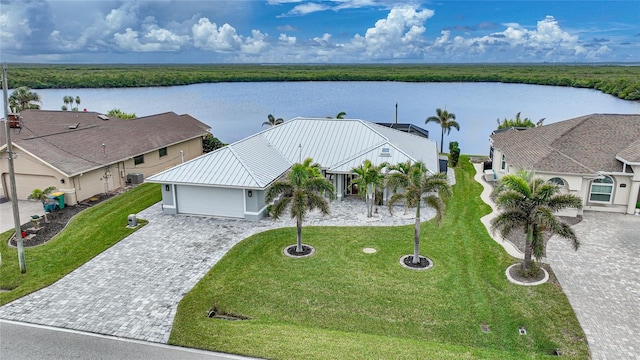 birds eye view of property with a water view